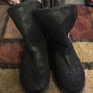 pair of boots that are slightly worn and size 3.